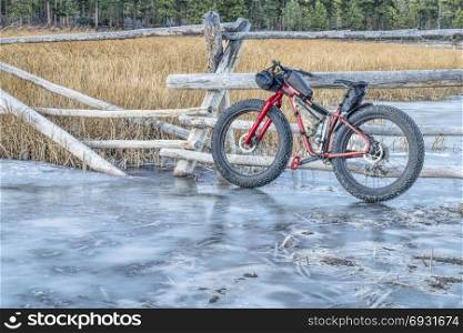 fat bike with frame bags on stream covered by ice in Colorado&rsquo;s Rocky Mountains