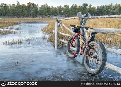 fat bike with frame bags on stream covered by ice in Colorado&rsquo;s Rocky Mountains
