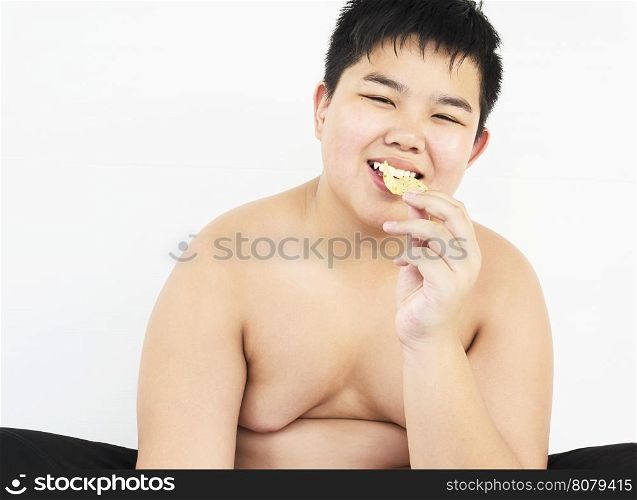 Fat boy is happily eating chip