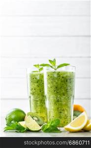 fat burning green fruit cocktail with kiwi, lemon, mint and parsley for slimming and healthy diet with space for a text