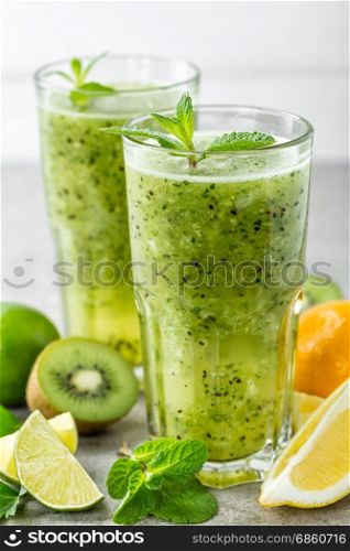 fat burning green fruit cocktail with kiwi, lemon, mint and parsley for slimming and healthy diet