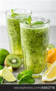 fat burning green fruit cocktail with kiwi, lemon, mint and parsley for slimming and healthy diet