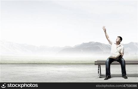 Fat man. Fat man sitting on bench with book and pointing with finger