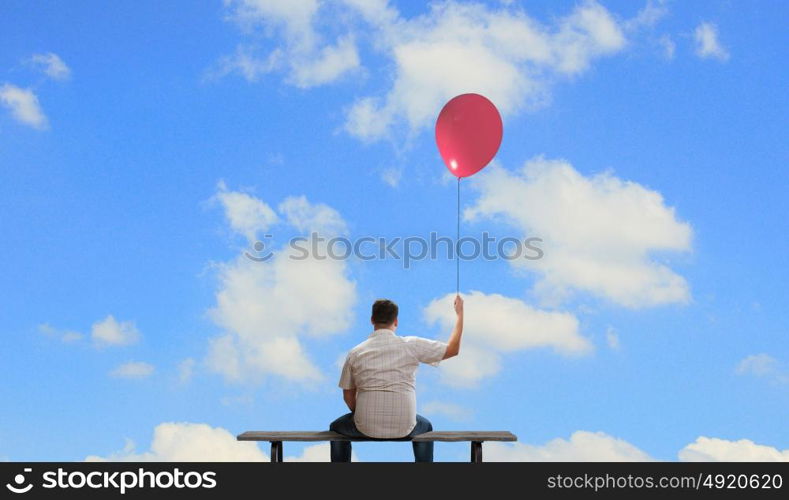 Fat man. Fat man sitting on bench with his back with balloon in hand