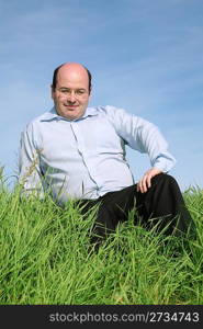 fat man sitting grass