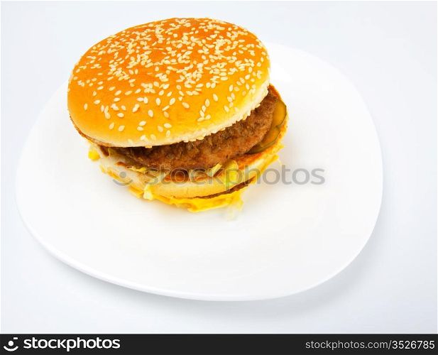 fat sandwich on white dish, grey background