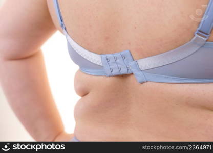 Fat woman in bra, rear view. Clasp hook detail. Plus size overweight female wearing lingerie. Bosom, underwear and proper fitting bras.. Woman wearing bra back view. Clasp band detail.