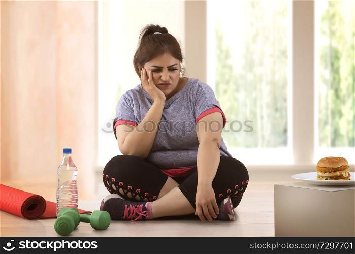 fat woman making choice between exercising and unhealthy eating