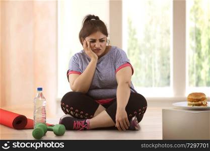 fat woman making choice between exercising and unhealthy eating
