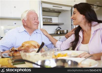 Father And Adult Daughter Having Family Meal At Table