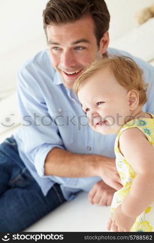 Father and baby daughter at home