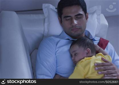 Father and baby sleeping