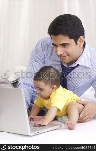 Father and baby with laptop