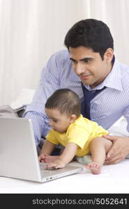 Father and baby with laptop