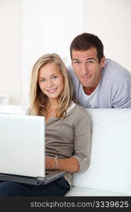 Father and child at home looking at internet