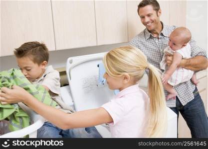 Father And Children Doing Laundry