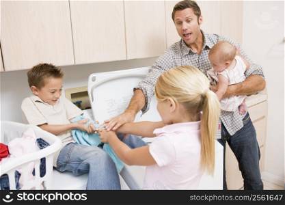 Father And Children Doing Laundry