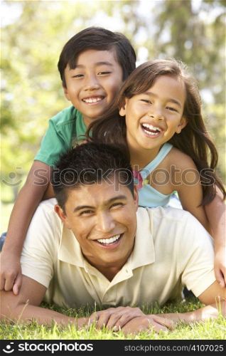 Father And Children Enjoying Day In Park