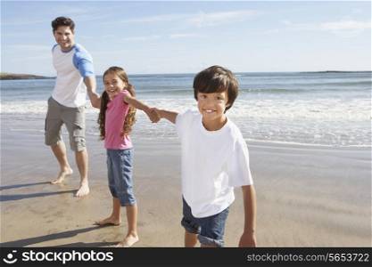 Father And Children Having Fun On Beach Holiday