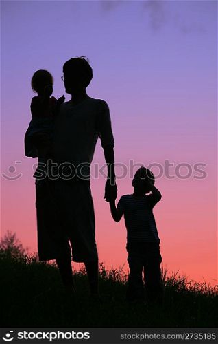 father and children on sunset
