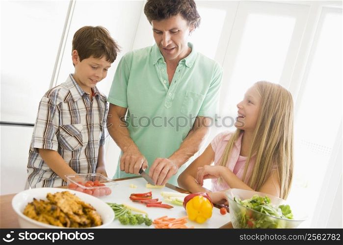 Father And Children Prepare A meal,mealtime Together