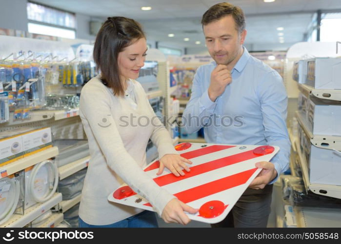 father and daughter buying rear warning sign for car