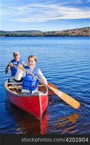 Father and daughter canoeing on Lake of Two Rivers, Ontario, Canada