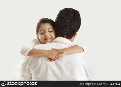 Father and daughter embracing over white background