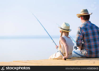 Father and daughter fishing. Father and daughter fishing on the pier