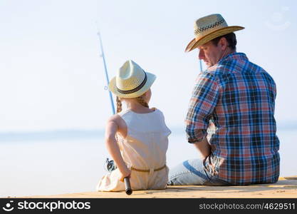 Father and daughter fishing. Father and daughter fishing on the pier