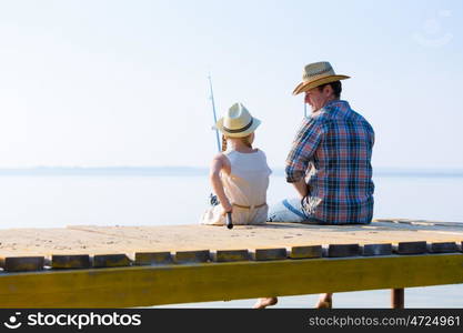 Father and daughter fishing. Father and daughter fishing on the pier