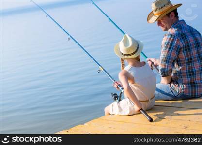 Father and daughter fishing. Father and daughter fishing on the pier