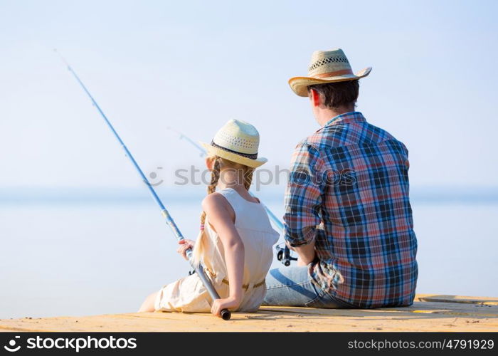 Father and daughter fishing. Father and daughter fishing on the pier