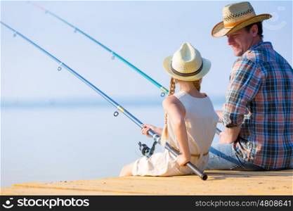 Father and daughter fishing. Father and daughter fishing on the pier