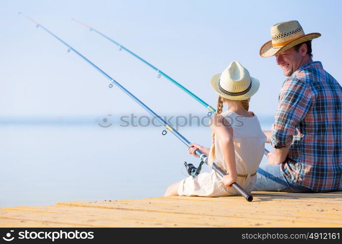 Father and daughter fishing. Father and daughter fishing on the pier