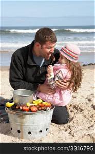 Father And Daughter Having Barbeque On Winter Beach