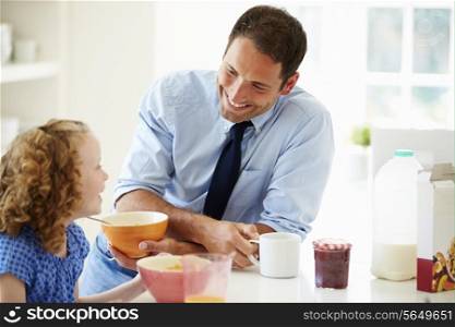 Father And Daughter Having Breakfast In Kitchen Together