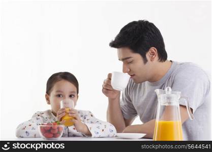 Father and daughter having breakfast together