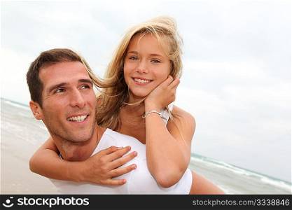 Father and daughter having fun at the beach