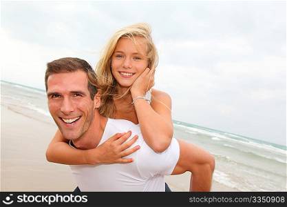 Father and daughter having fun at the beach