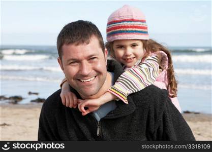 Father And Daughter Having Fun On Beach Together
