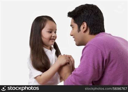Father and daughter holding hands over white background
