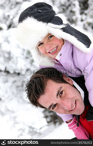 Father and daughter in the snow