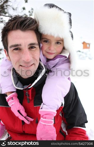 Father and daughter in the snow