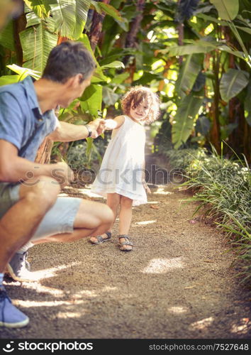 Father and daughter in the tropical garden