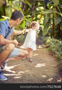 Father and daughter in the tropical garden