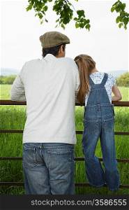 Father and Daughter Looking on Farmland