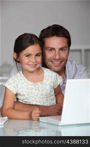 Father and daughter on laptop