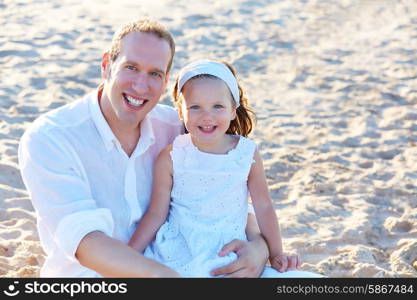 Father and daughter on the beach sand together happy