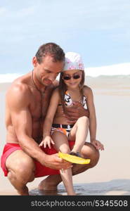 Father and daughter playing at the beach